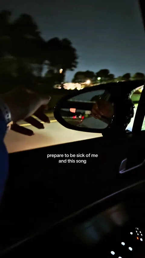 Nighttime car post about a song on repeat