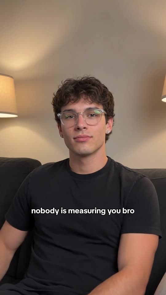 The payoff frame: the answer line lands across the character's black t-shirt at the moment he lowers his phone and looks into the camera
