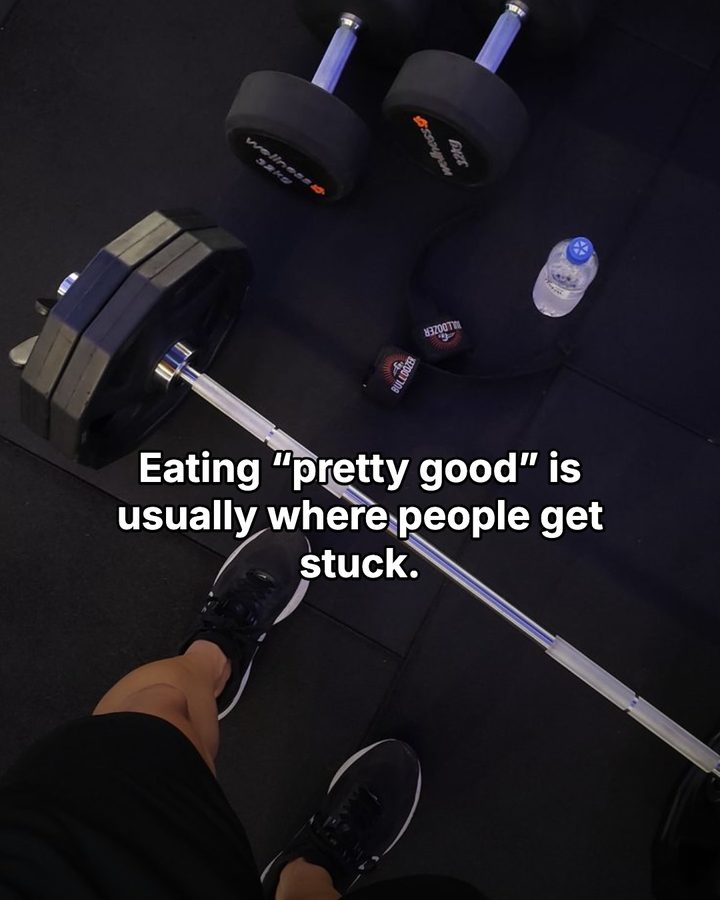 Carousel slide reading “Eating pretty good is usually where people get stuck.” over a set of dumbbells